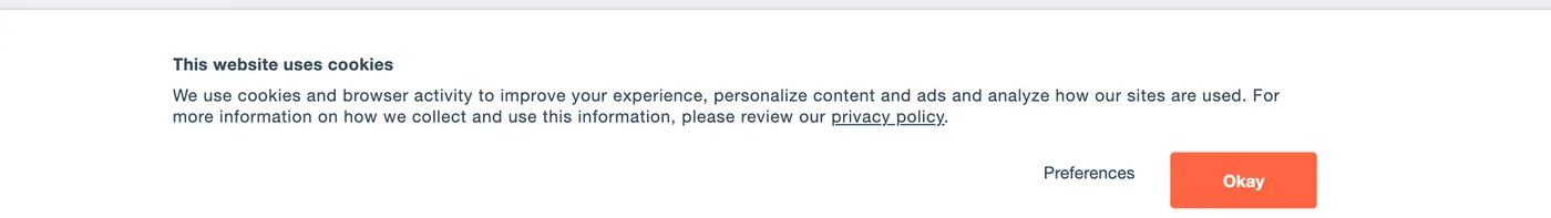 The Cookiebot consent banner on domino.ai, reading This website uses cookies, with Preferences and Okay buttons.